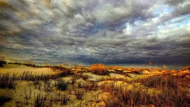 Dark, heavy skies over coastal terrain