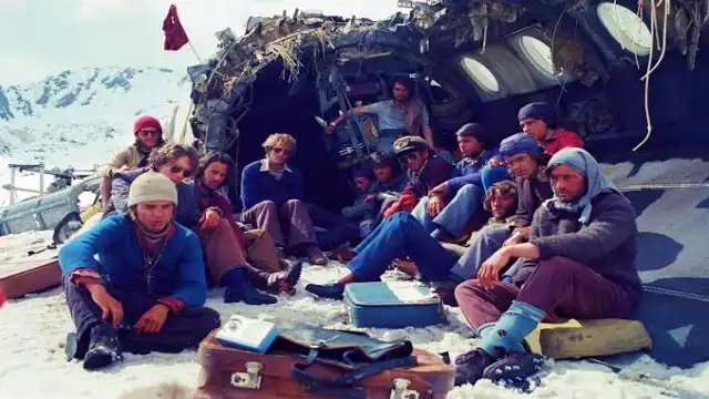 Survivors beside the crashed fuselage