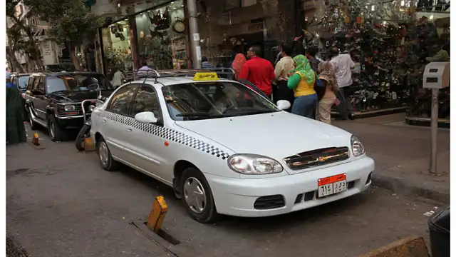 Cairo Uber vs Taxi: Safety, Scams & Best Apps (2027) Cairo white taxi street